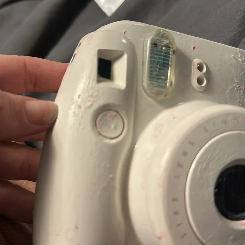 Camera Works properly. Someone painted it white though. With pink carry case .